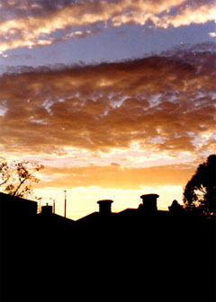 Sun setting over rooftops